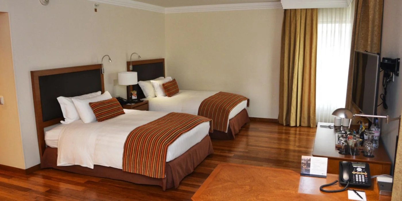 Private twin room with two beds and desk space.