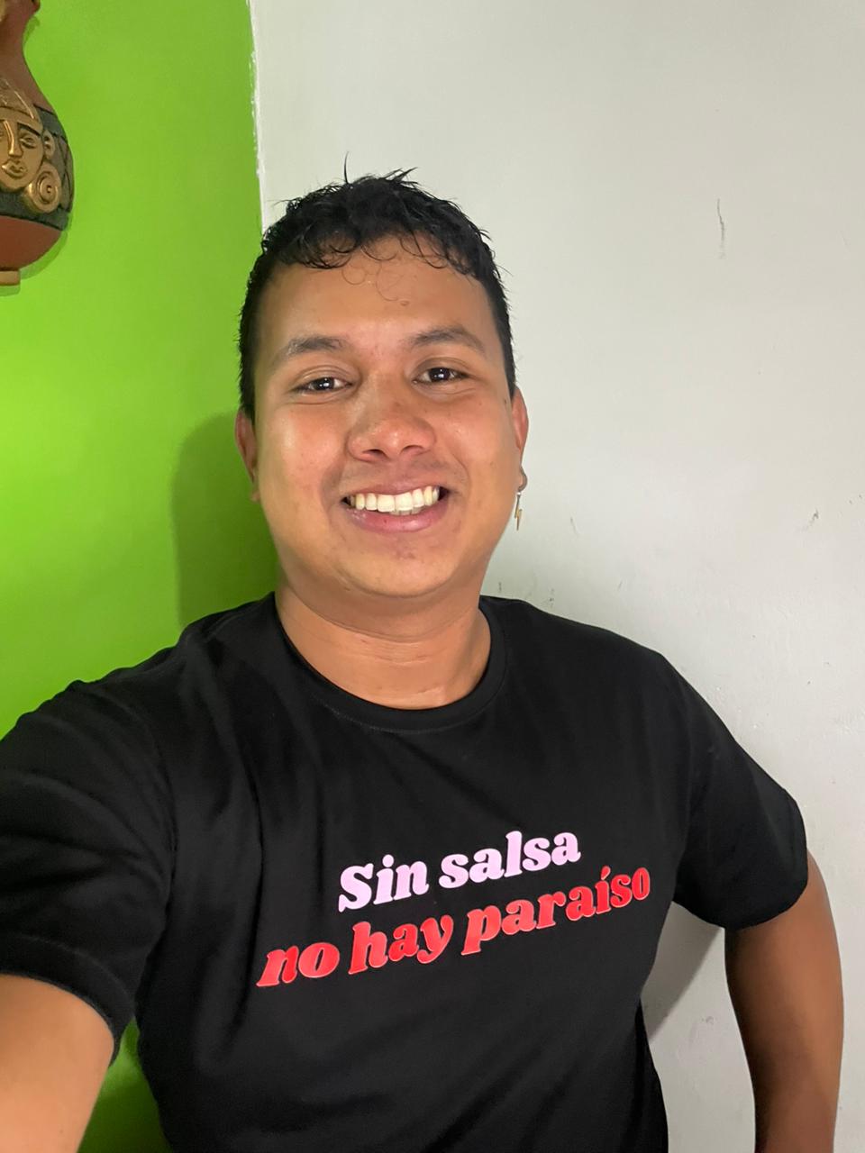 Julian Villa smiling in a Rumba shirt.